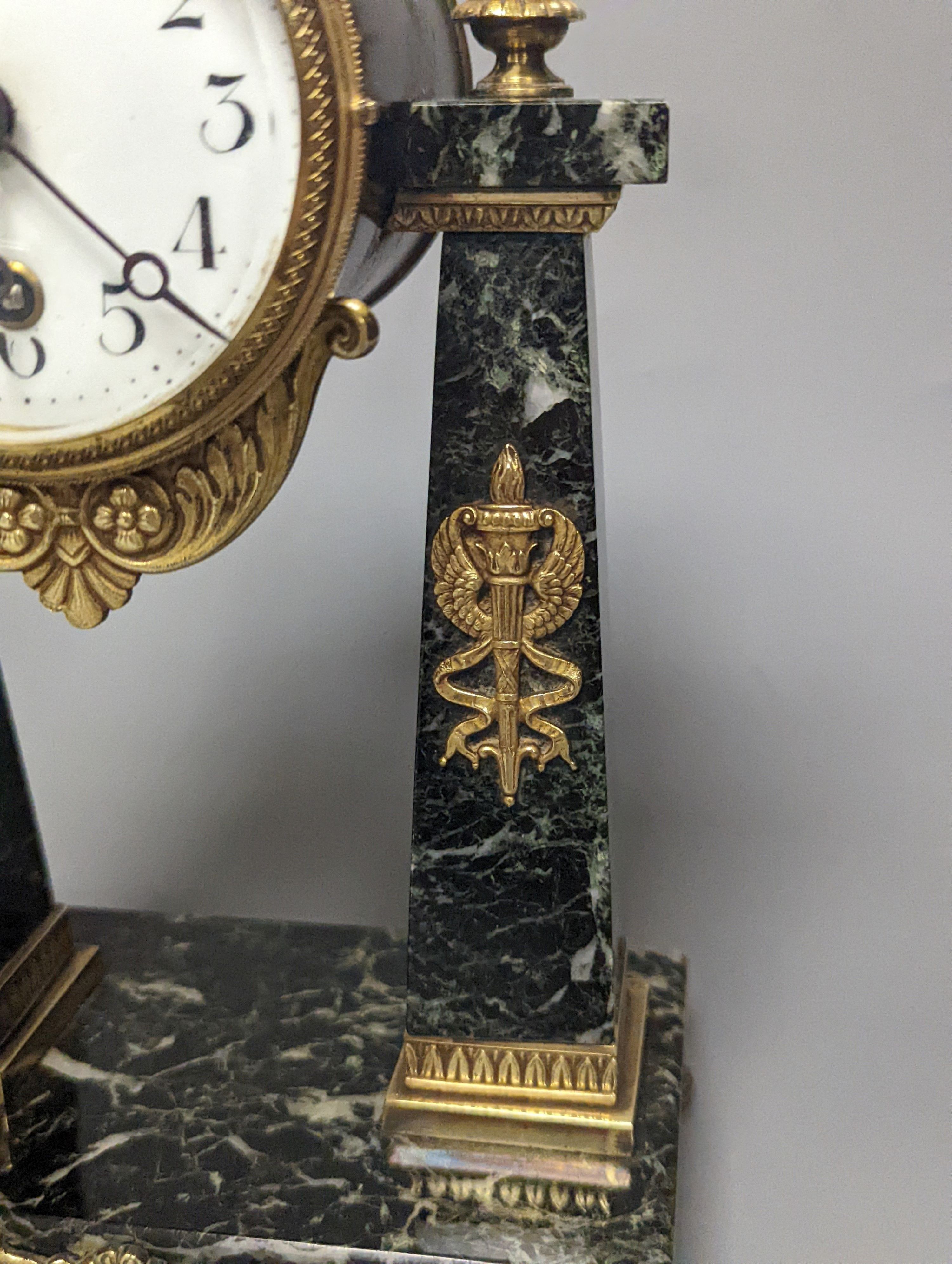 A French Empire style marble and ormolu portico timepiece 32cm